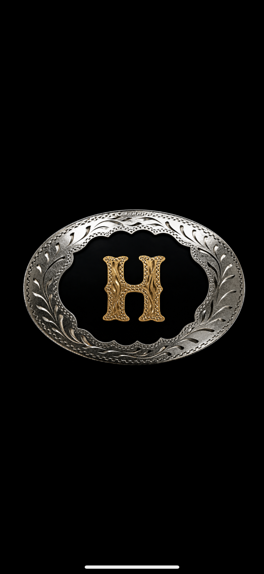 Ornate silver and gold western belt buckle featuring the letter H — the inspiration for the Big H Knives logo